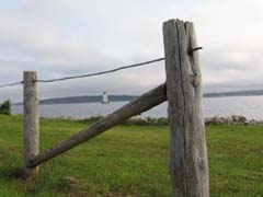 Lighthouse through fence